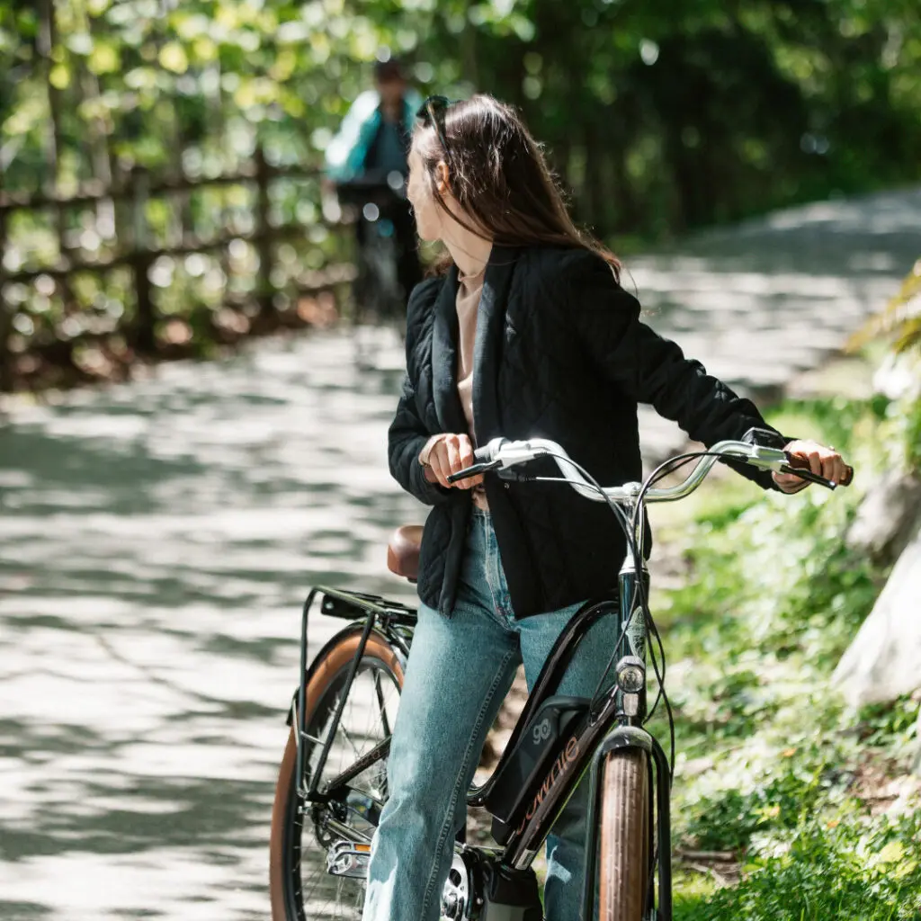 A woman on a bike waiting for her friend to catch up in the neighbourhood bike trails near Morrison Walk in North Vancouver